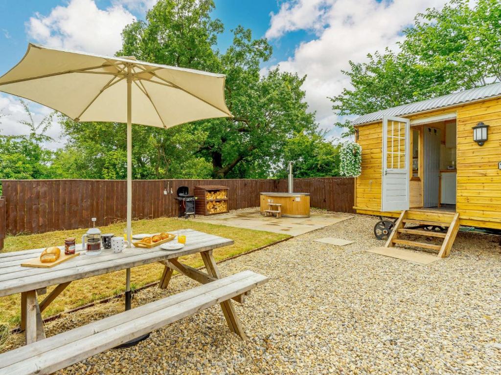 a picnic table with an umbrella in a backyard at 1 bed in Stapleton 88970 