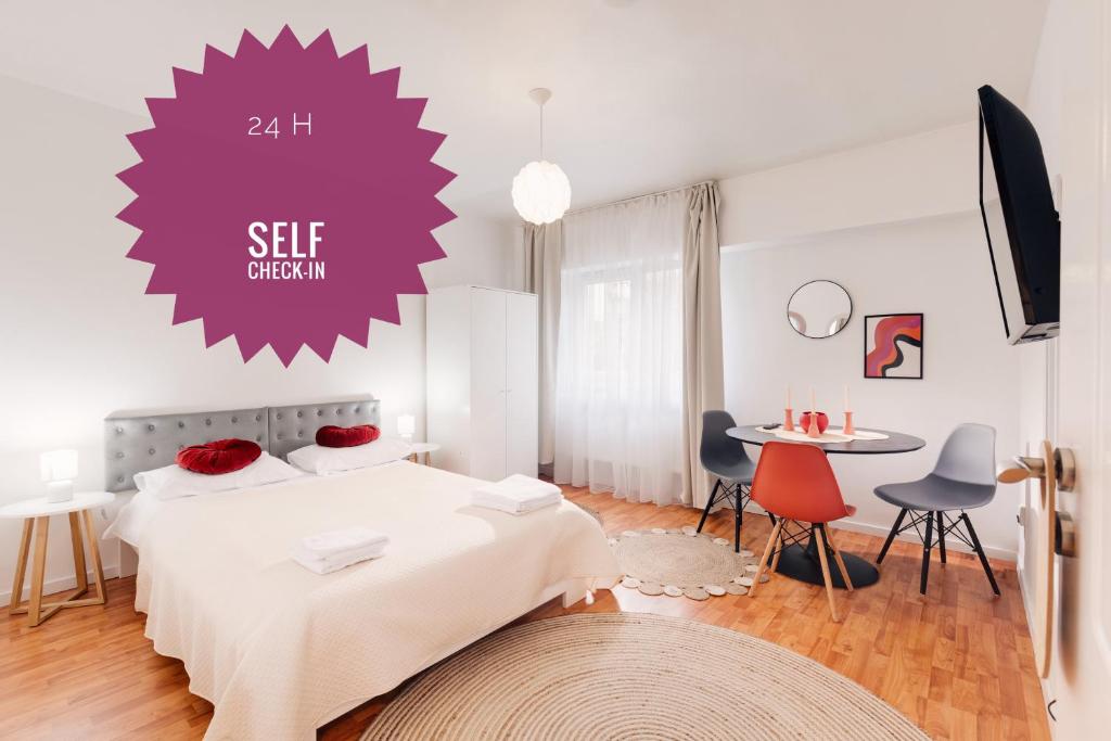 a bedroom with a bed and a table and chairs at Perfect Stay CIPARIU in Cluj-Napoca
