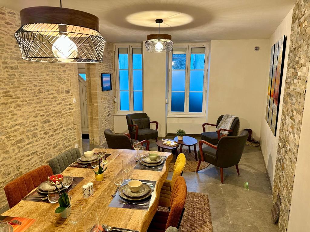 a dining room with a table and chairs at Cosy village house with home cinema in Grandcamp-Maisy