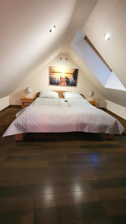 1 dormitorio con 1 cama grande en el ático en Nadmorski Apartament Rodzinny en Żarnowska