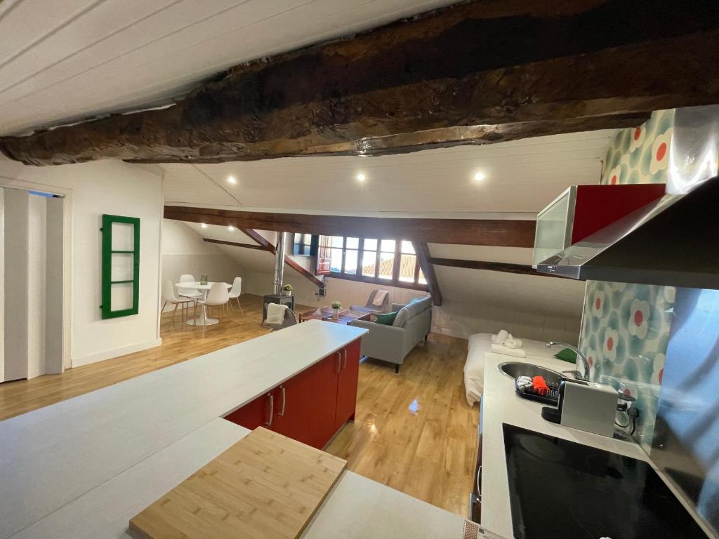 a kitchen and living room with a counter top at APARTAMENTOS "Plaza de la Iglesia" in Vigo