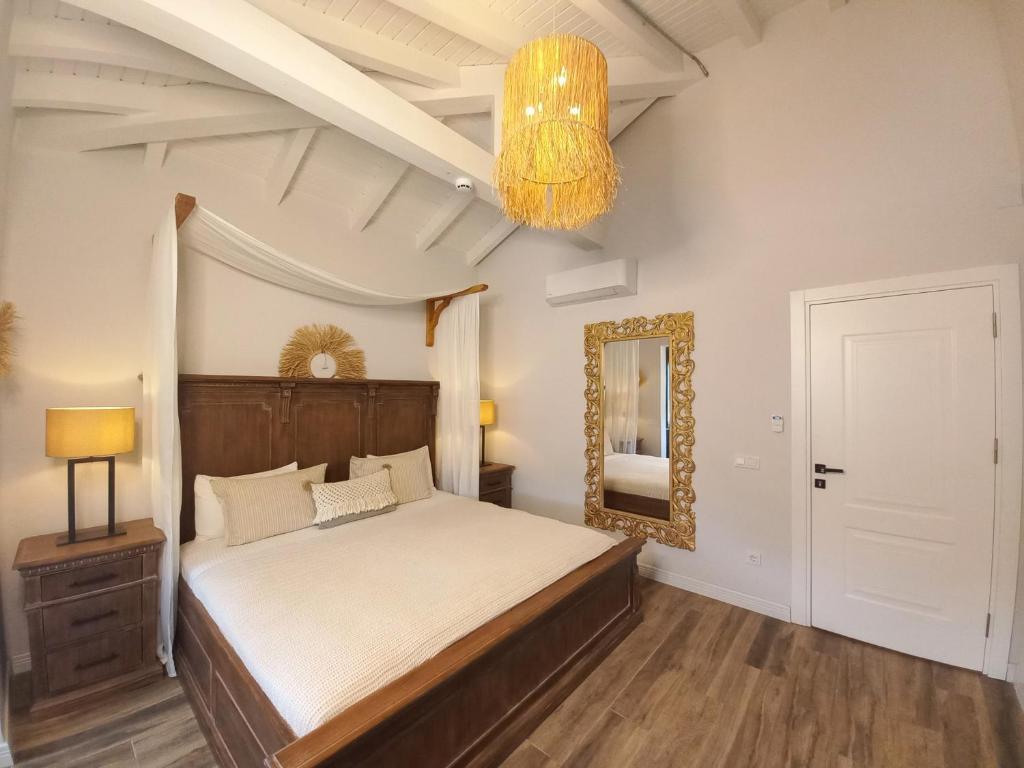 a bedroom with a large bed and a chandelier at Chloe hotel Alacati in Alacati