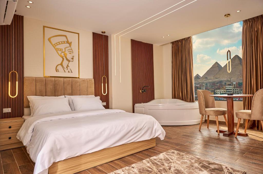 a bedroom with a bed and a bathroom with a tub at Rotana Pyramids View in Cairo