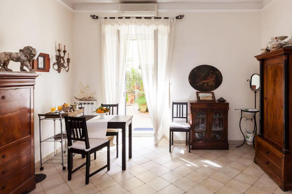 a dining room with a table and chairs and a window at Vacanze Romane in Rome