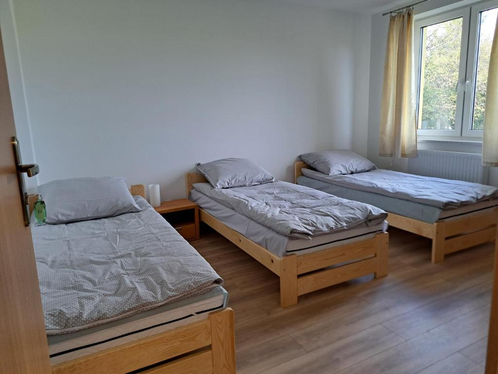 A bed or beds in a room at P&P noclegi - Krosno Sikorskiego