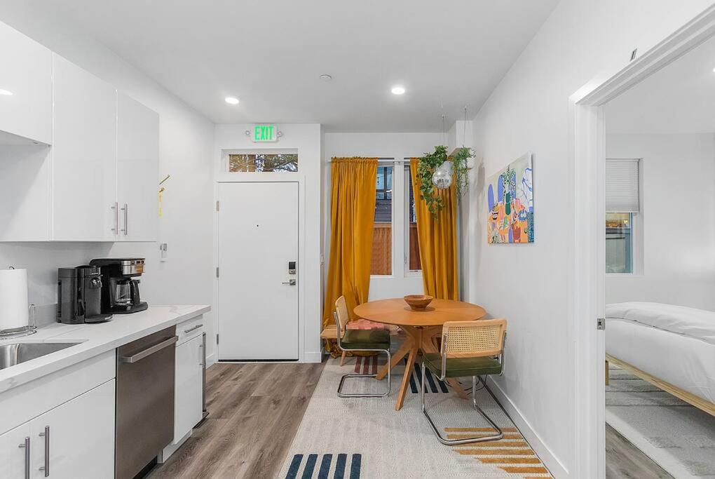 a kitchen with a wooden table in a room at Cozy Oasis in the heart of Capitol Hill in Seattle