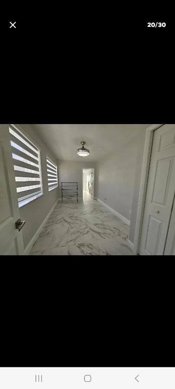 a room with a hallway with a bench and a door at Villa hermosa in Key Largo