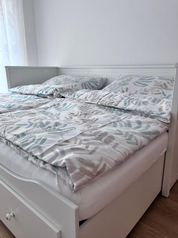 an unmade bed in a bedroom with a white bed frame at Danube22 Apartment 2 in Vienna