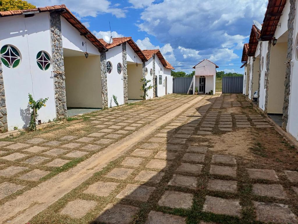 a street in a village with white buildings at Hotel Mar de Minas in Três Marias
