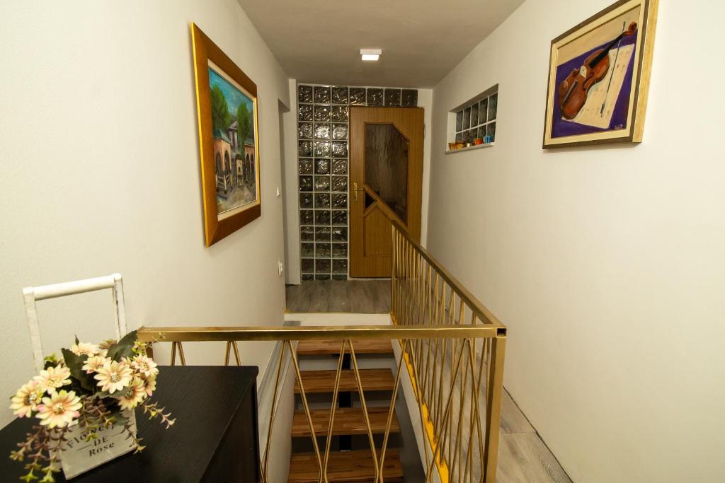 a room with a staircase with a table and a door at Guest House Lejla in Travnik