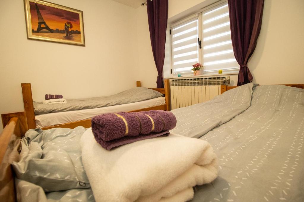 a bedroom with two beds with towels on them at Guest House Lejla in Travnik