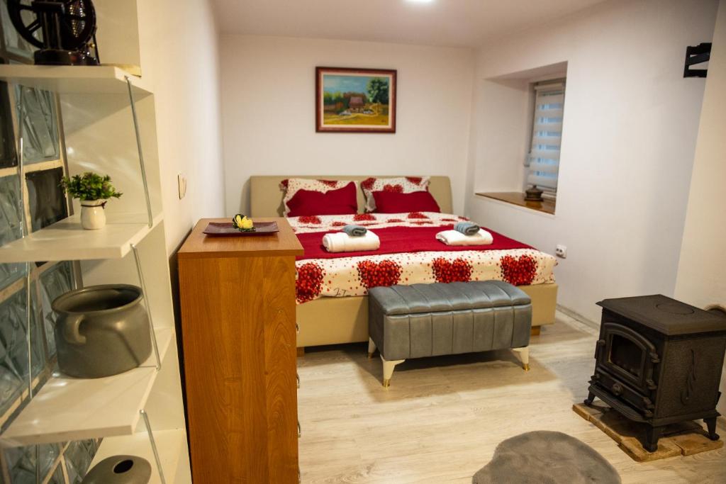 a bedroom with a bed and a wood stove at Guest House Lejla in Travnik