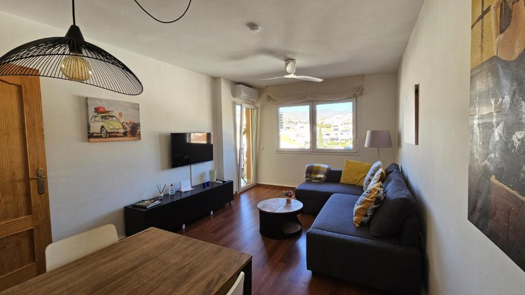 a living room with a couch and a table at Apartamento Marion in Cala del Moral