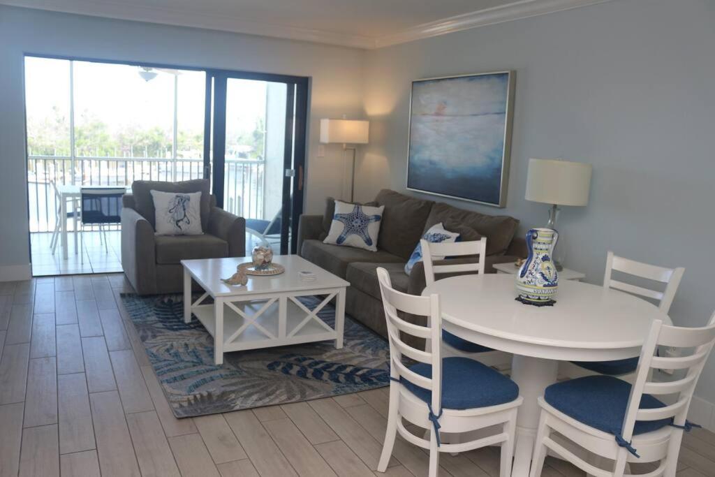 a living room with a table and a couch at Captiva Bayside Villas 1 Bedroom 2 Bath - sleep 4 in Captiva