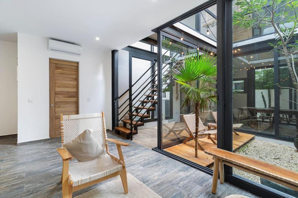 un salon avec deux chaises et un escalier dans l'établissement Stunning 4br - Rooftop Pool, 5 mins to beach, à Tulum