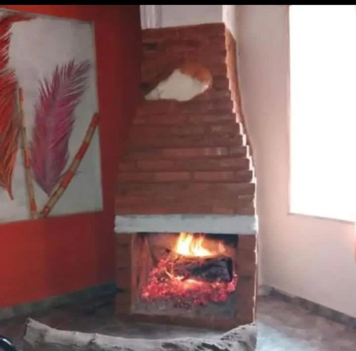 a woodburning oven in a room with a staircase at La Gallega in San Javier