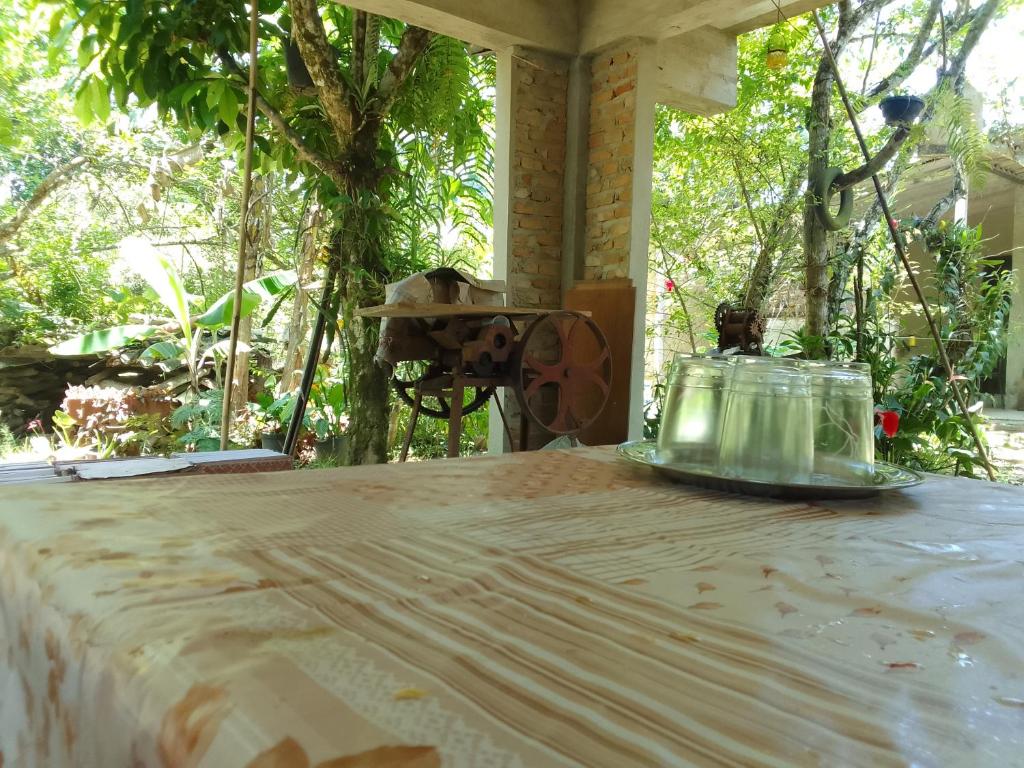 a table with a glass jar on top of it at Suítes Recanto Dos Passarinhos 2 in Ubatuba