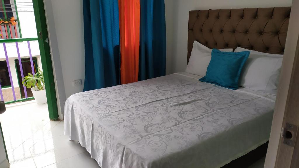 a bedroom with a bed with a blue pillow at Loft urbano apartamento in Salento