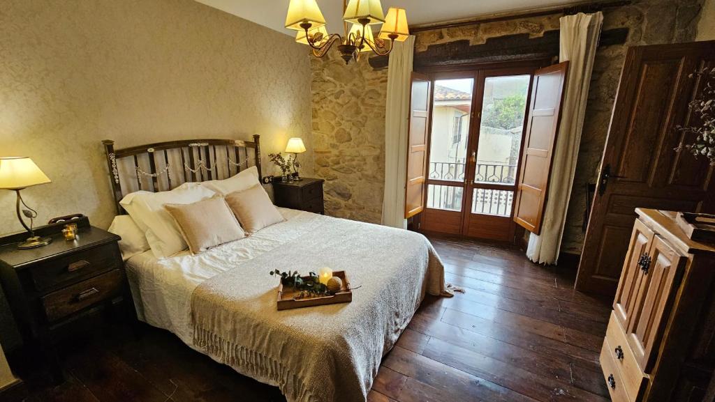 a bedroom with a bed with a tray of food on it at La Clerecia de Ledesma in Ledesma