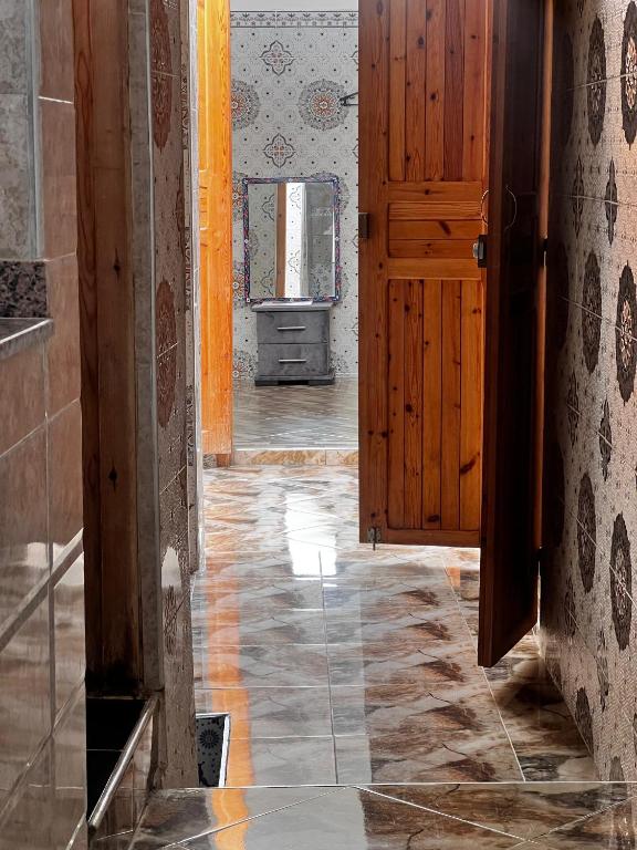 an open door in a room with a tile floor at Dar Lala Haniya in Rabat