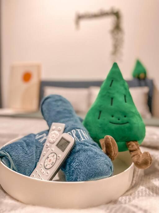 a stuffed animal sitting in a bowl with a remote control at [Starry x GREEN @GreenHaven]3Beds2Bath in Masai