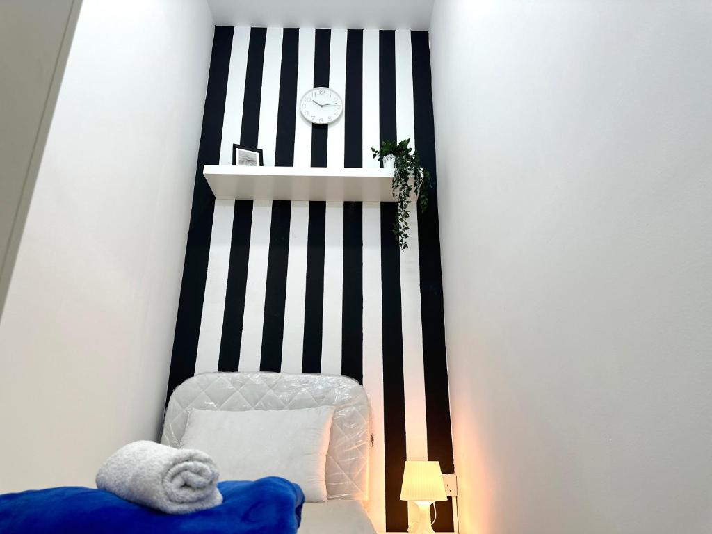 Postel nebo postele na pokoji v ubytování Striped Partition Room in Barsha 1 Near Mall of the Emirates