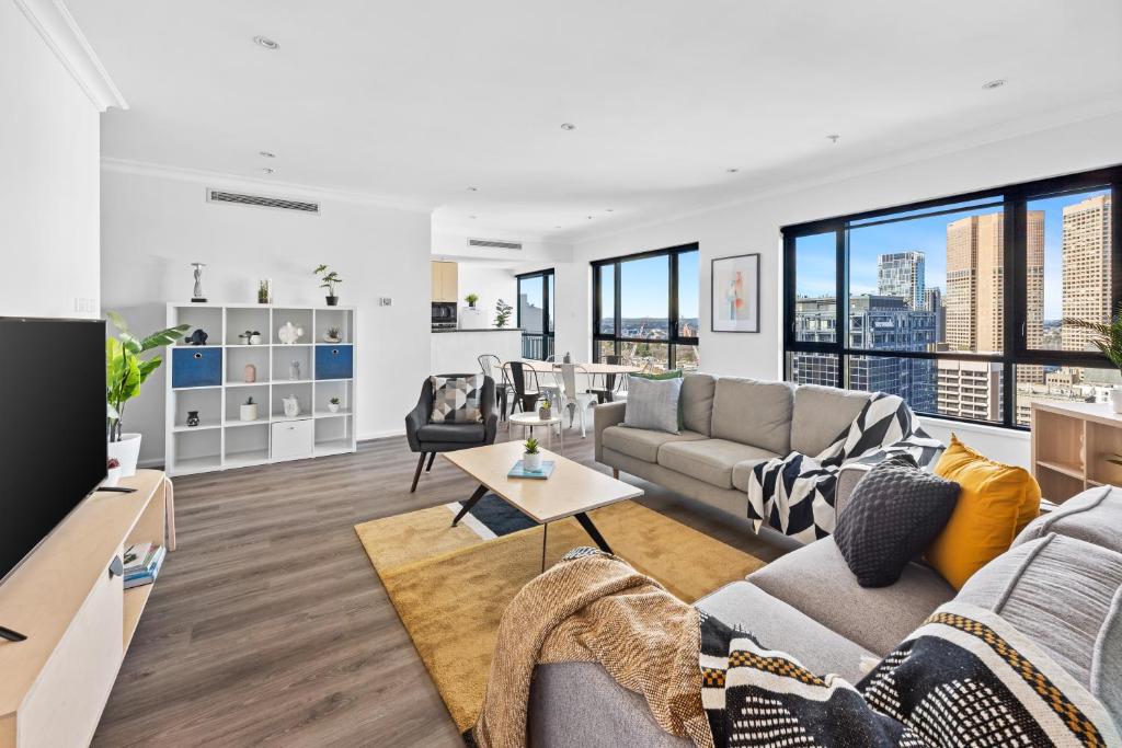 a living room with a couch and a table at Regency Towers in Melbourne