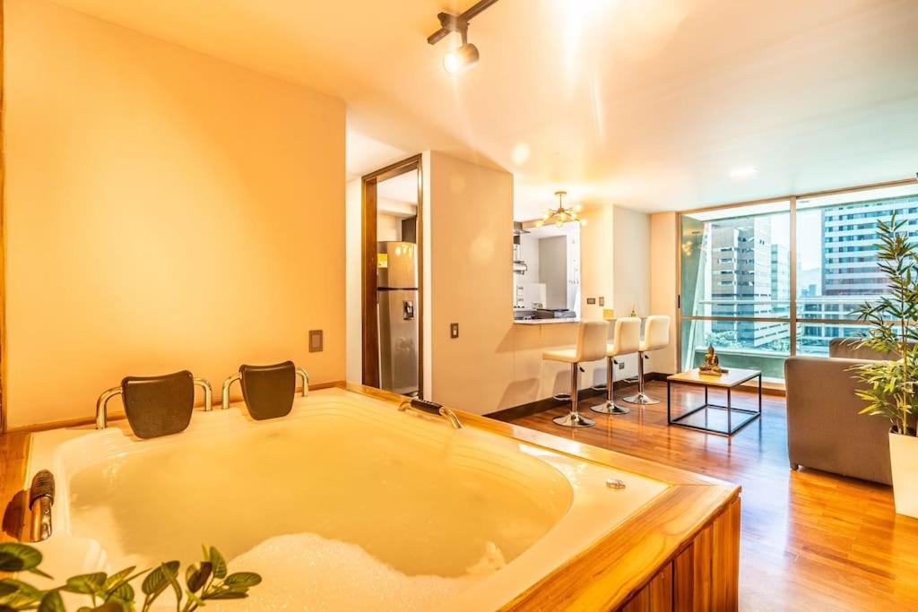 a large bathroom with a large tub in a room at Apartamento familiar con jacuzzi El Poblado in Medellín