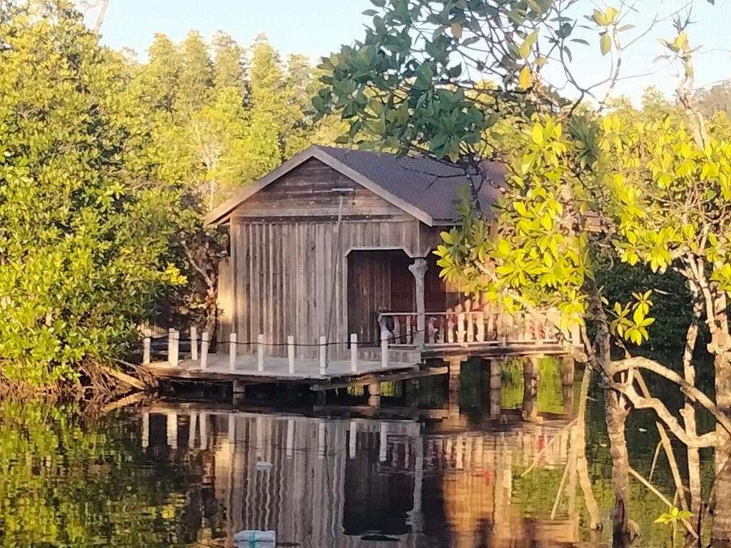 a boathouse on a dock in the water at Friend of Nature Bungalow in Koh Rong Island