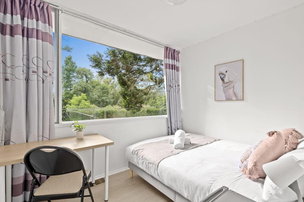 a bedroom with a bed and a desk and a window at Cozy Double Room in Pymble Sleeps 2 in Pymble