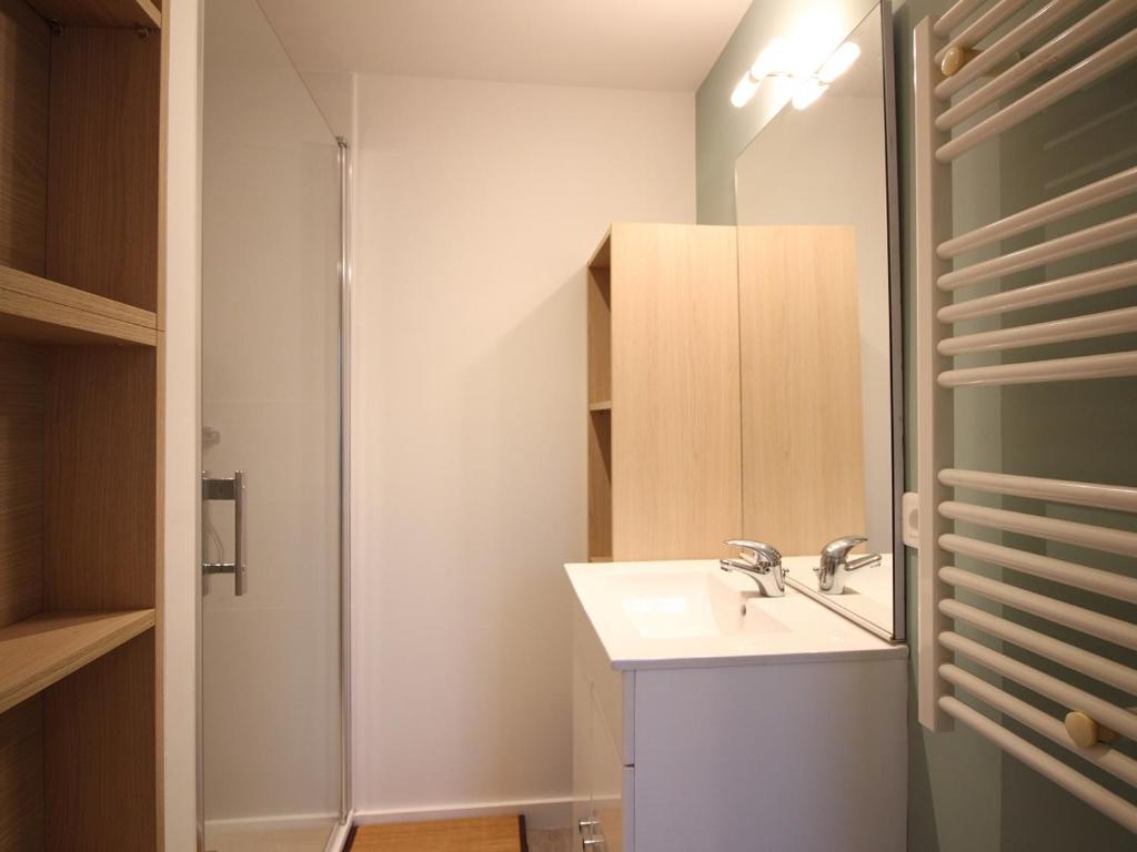 a bathroom with a sink and a mirror at Appartement La Bourboule, 3 pièces, 4 personnes - FR-1-608-261 in La Bourboule