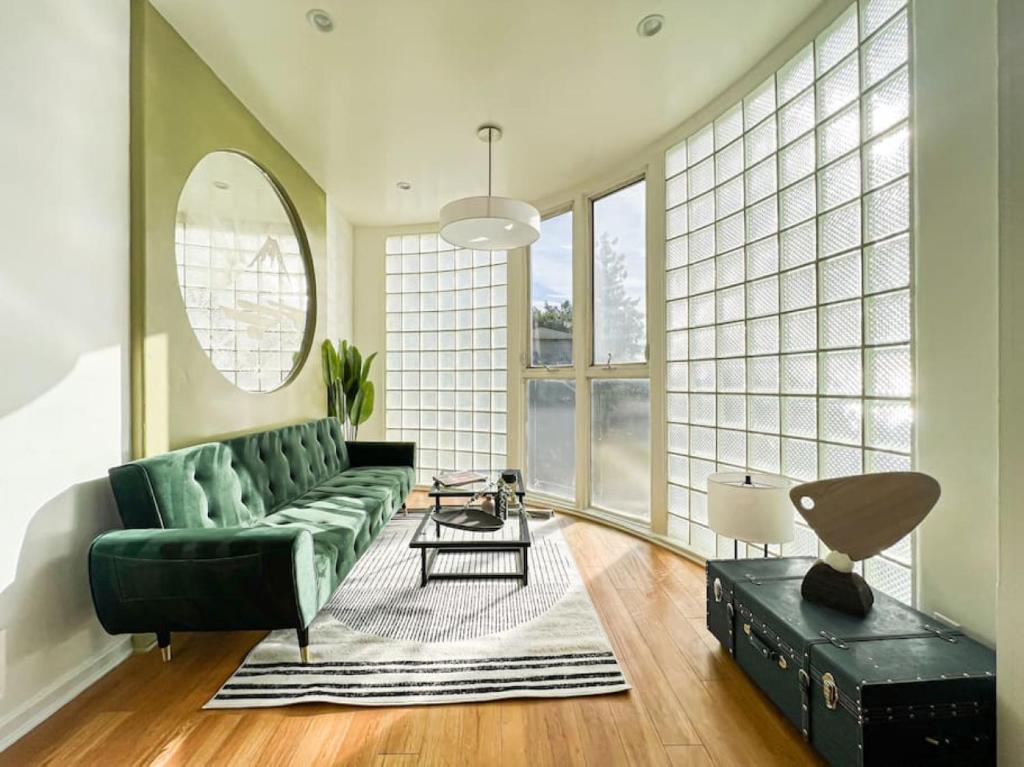 a living room with a green couch and a table at 3BR Stylish Residence in Los Angeles - OL in Los Angeles