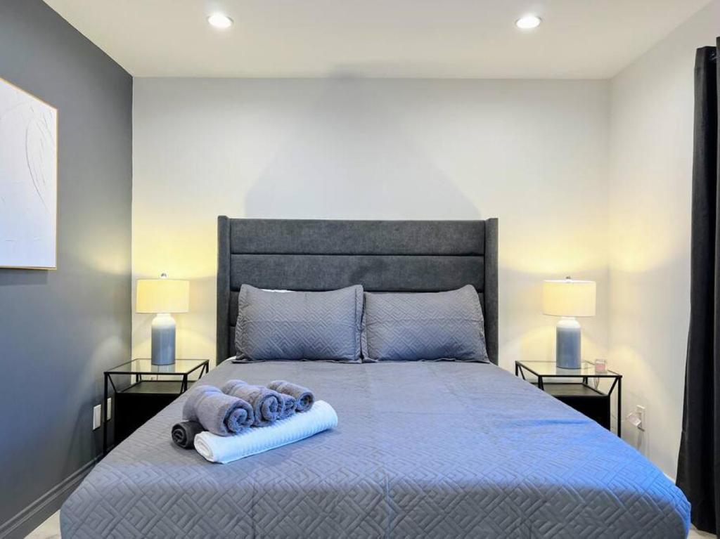 a bedroom with a large bed with two lamps at Spacious 2BR near Hollywood - BR3 in Los Angeles