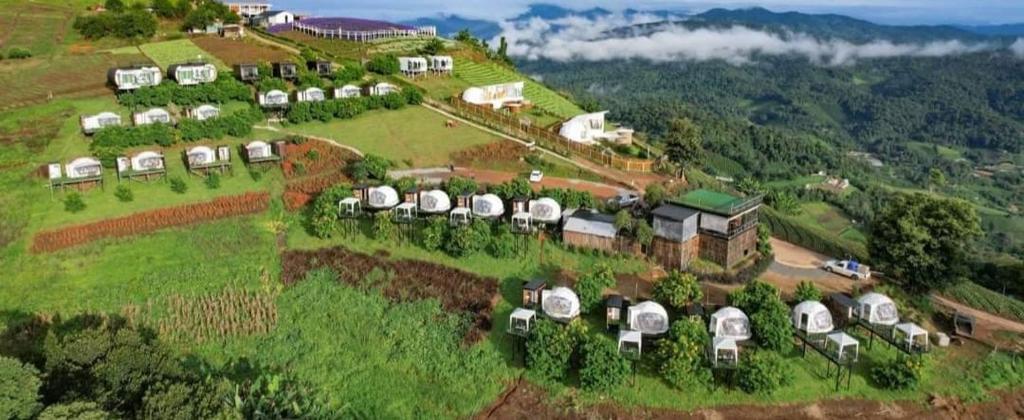an aerial view of a house on a hill at ม่อนหมอกฟ้า ม่อนแจ่ม in Mon Jam