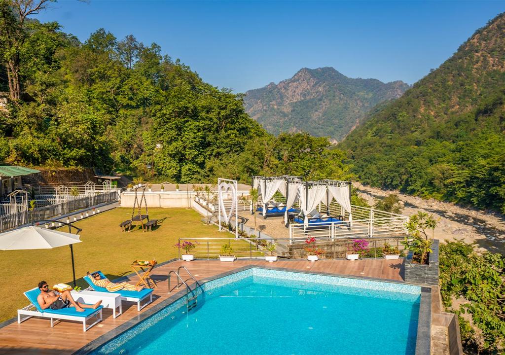 a swimming pool with a view of a mountain at Moustache Rishikesh Riverside Resort in Rishīkesh