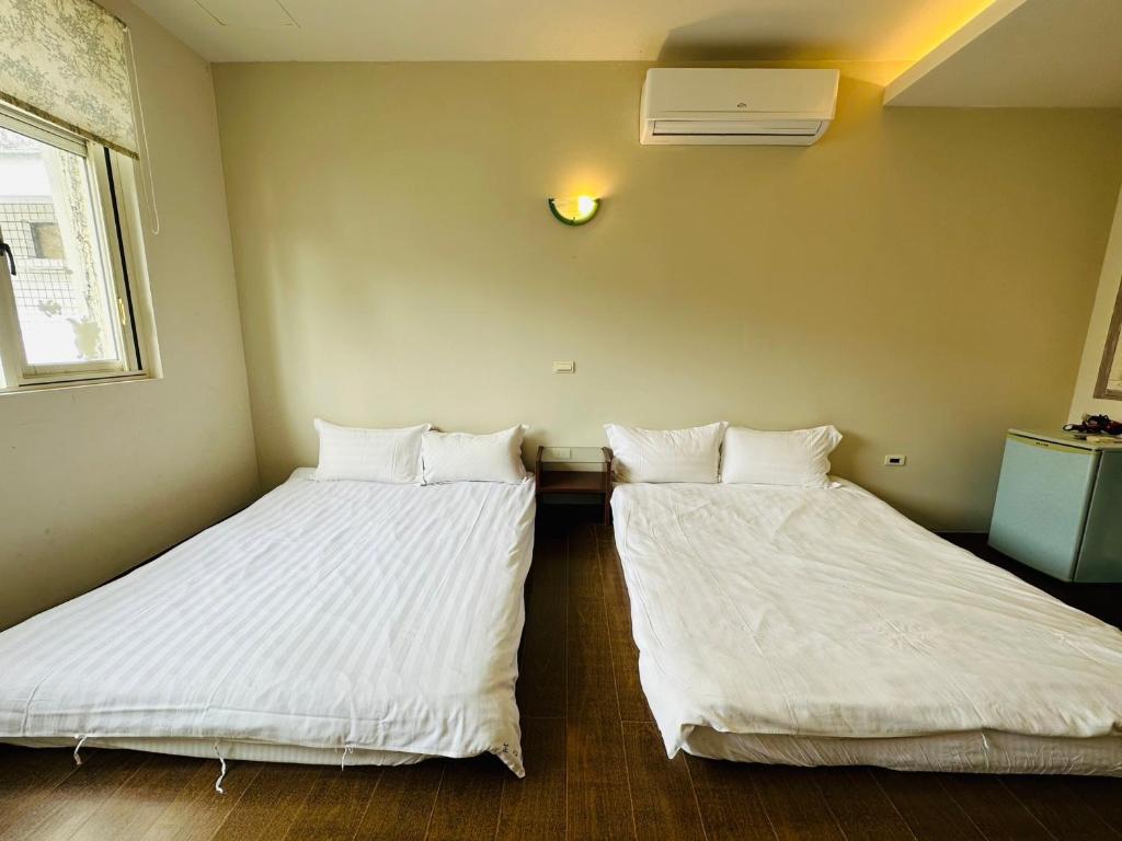 Postel nebo postele na pokoji v ubytování Zhixinyuan B&B