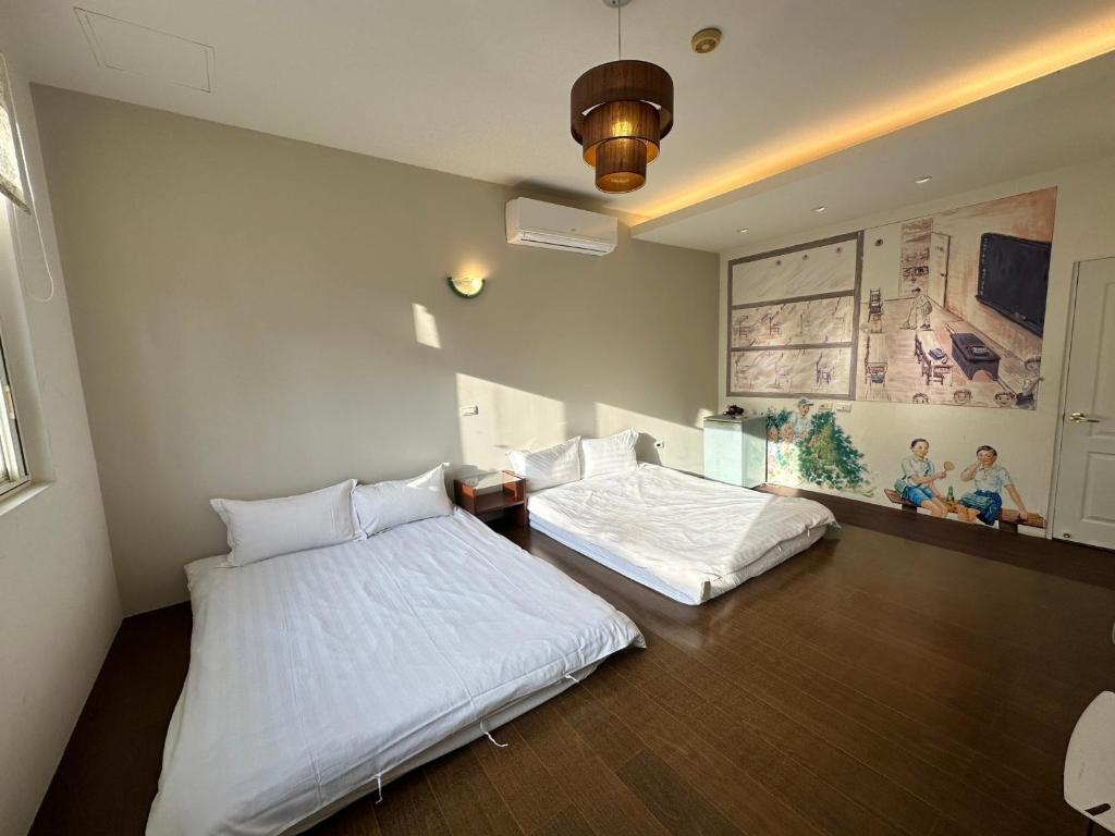 Postel nebo postele na pokoji v ubytování Zhixinyuan B&B
