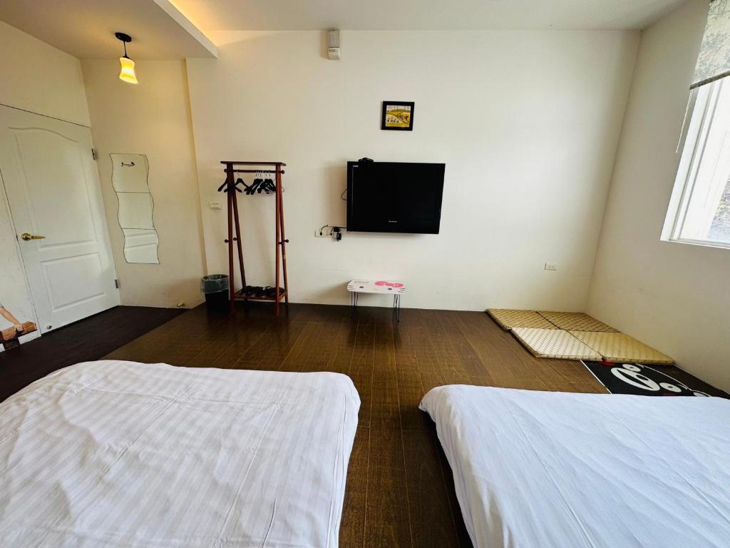 Postel nebo postele na pokoji v ubytování Zhixinyuan B&B