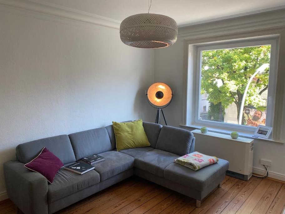 a living room with a couch and a window at Wohlfühlen in Winterhude in Hamburg