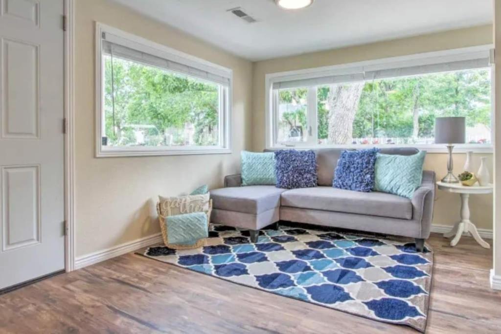a living room with a couch and a window at Tranquil Cottage Walk Downtown in Great Falls