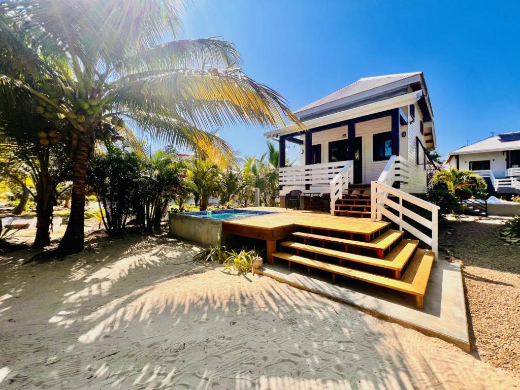 a house on the beach with a porch and a pool at La Vida Belize - Casita in Riversdale