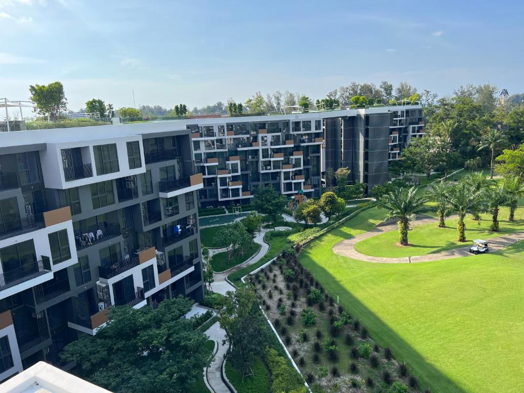 an aerial view of an apartment complex with a park at Cozy 1-bedroom Apartments in Laguna Skypark Bang Tao in Phuket Town