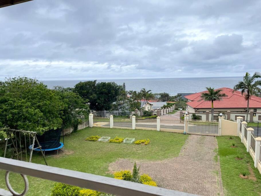 a view from a balcony of a yard with a playground at Sombedu guest suite in Margate
