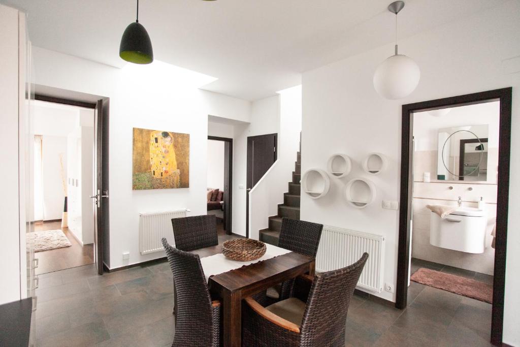 a dining room with a table and chairs and a mirror at Budapest Terrace Apartment in Budapest