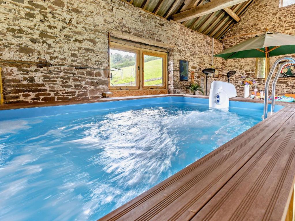 an indoor pool with blue water in a house at 1 Bed in Abergavenny BN113 in Pont Newydd