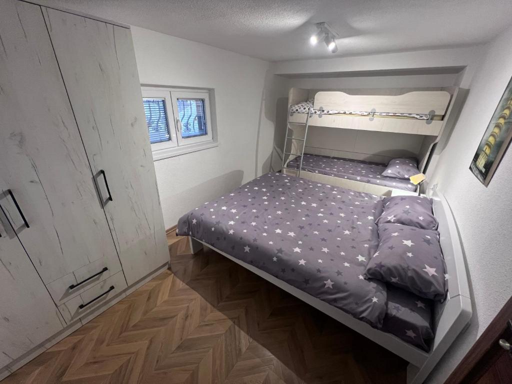 a small bedroom with a bunk bed in it at Mavrovo Square " Villas & Apartment " in Mavrovo