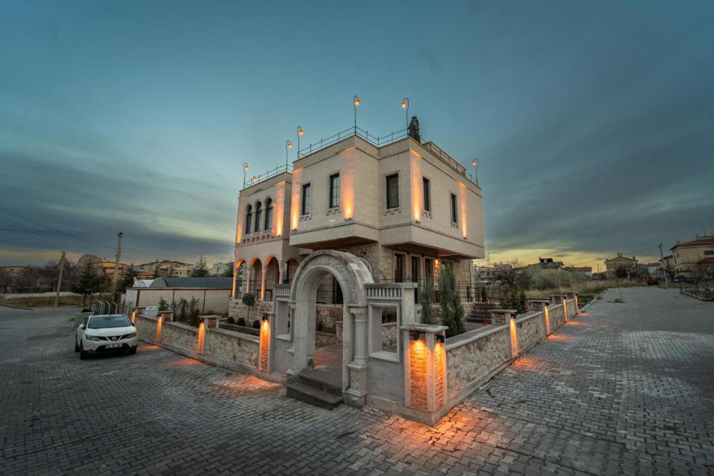 a white car parked in front of a building at Alin Stone House in Uchisar