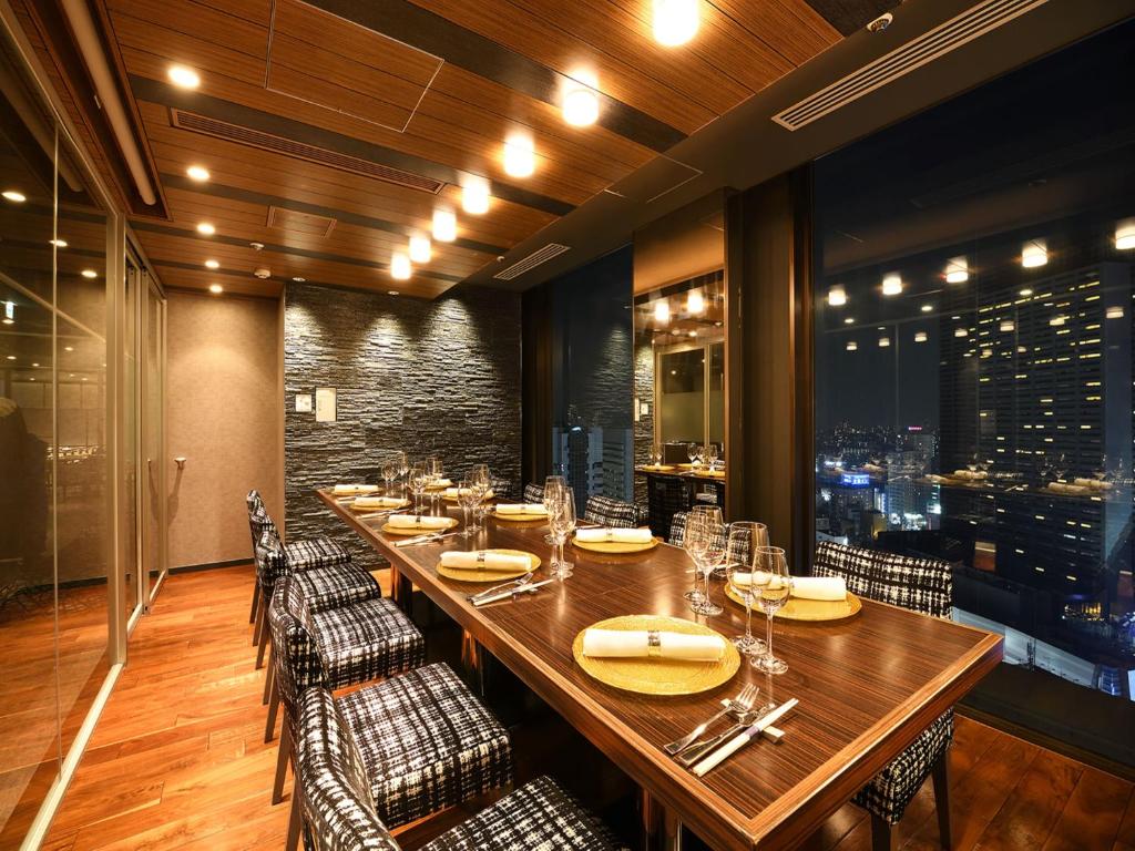 a dining room with a long table and chairs at Shinjuku Prince Hotel in Tokyo