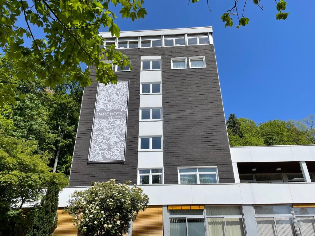 a building with a sign on the side of it at HARZ HOTEL und Gästehaus am Bornweg in Bad Sachsa