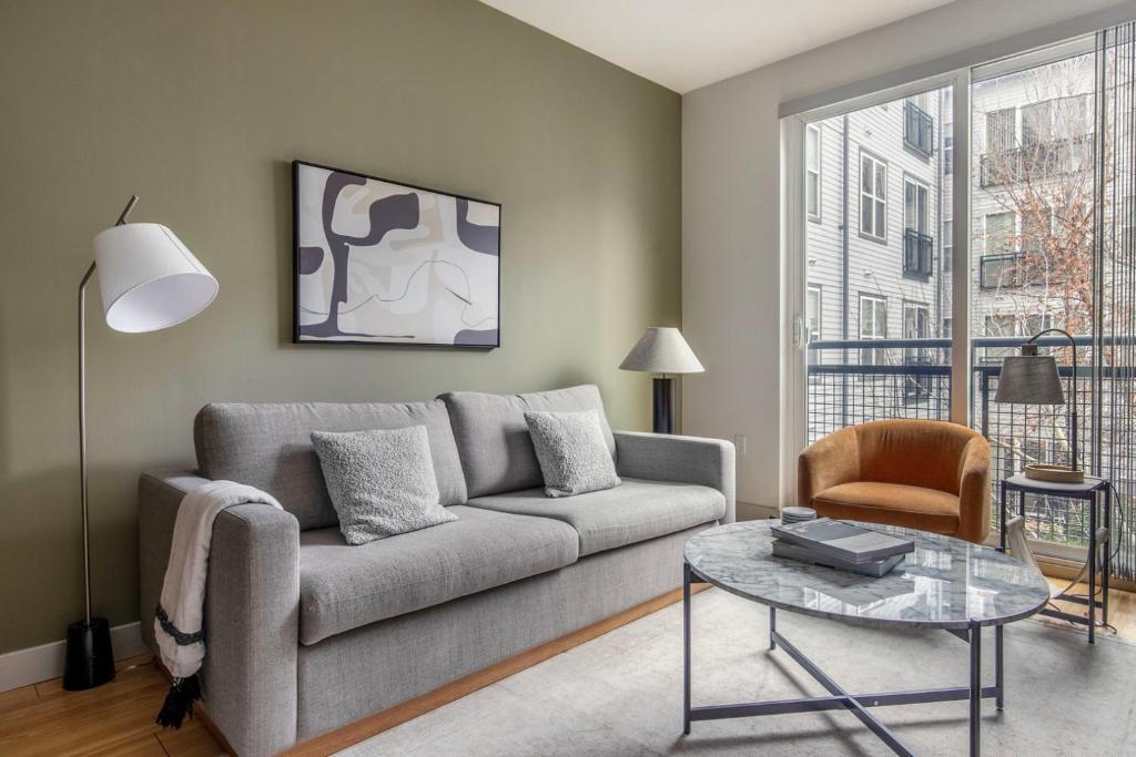 a living room with a couch and a table at South Boston 1br w gym nr red line shops BOS-984 in Boston